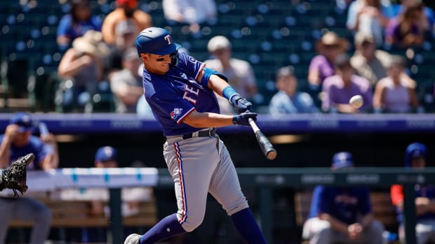 Aug 24, 2022; Denver, Colorado, USA; Texas Rangers first baseman Mark Mathias (9) hits a three RBI double in the second inning against the Colorado Rockies at Coors Field. Mandatory Credit: Isaiah J. Downing-USA TODAY Sports